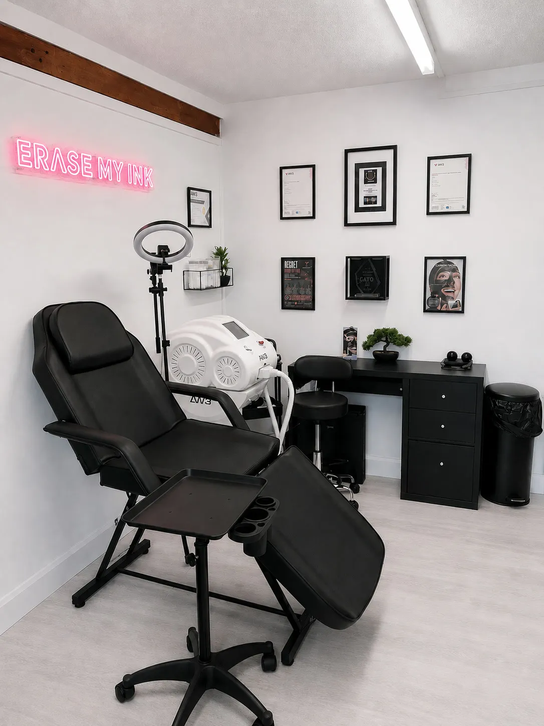 The Erase My Ink treatment room, with the neon sign, treatment chair and laser